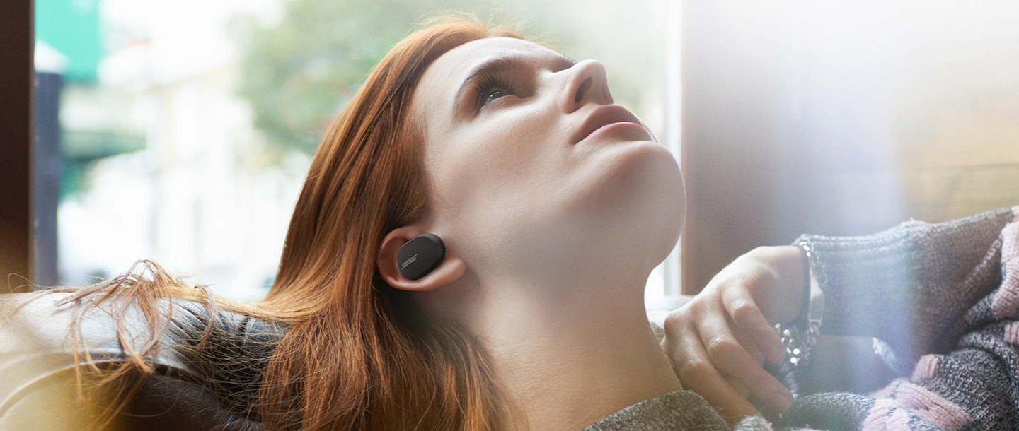 woman laying down and listening to music